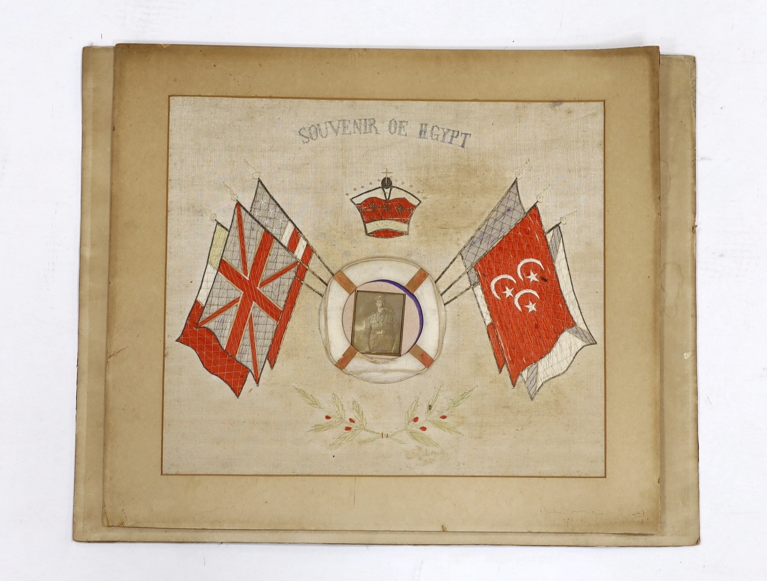 Two First World War souvenir embroideries mounted on boards, one relating to Egypt and another in memory of Laguerre 1914-15-16, both with contemporary photographs of soldiers at the centre, largest 50.5 x 63cm